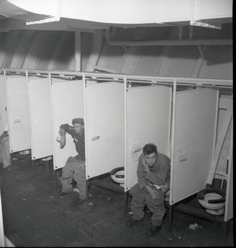 Soldiers using the latrine on the USS Meigs