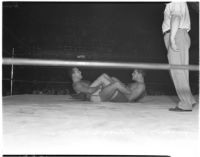 Wrestlers Martinez and Sanandos in a leg lock during their match, Los Angeles