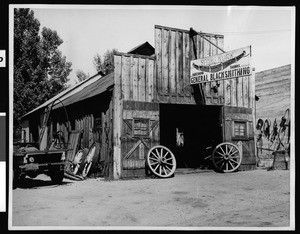 Exterior view of the Hartshorn and Thomos blacksmith shop in Bishop, ca.1930