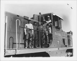 Men standing on Engine no. 3 of the P. & S.R, Petaluma, California, 1958