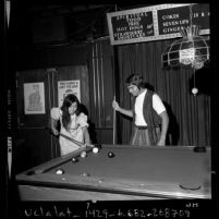 Couple playing pool at Christian nightclub, Right On in Los Angeles, Calif., 1971
