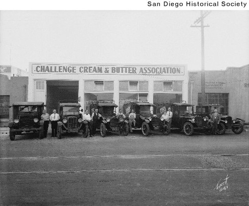 Men standing with delivery trucks outside the Challenge Cream & Butter Association