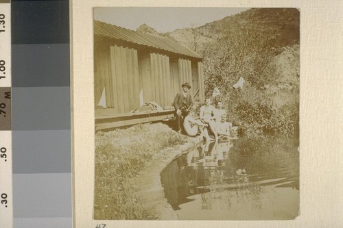 [Man in suit with nude men, beside pond. Herman George Scheffauer, second from left.]