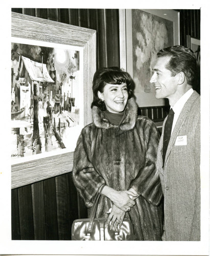 Bob Wood and woman at an art exhibit, mid 1960s