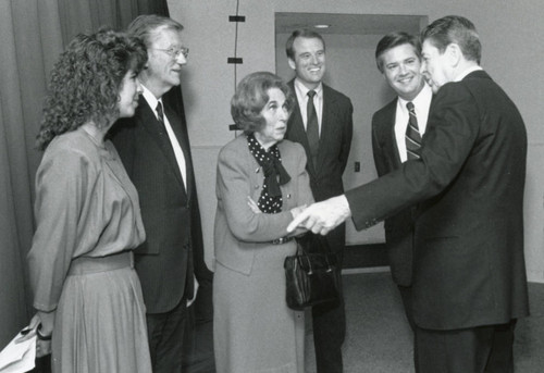 President Reagan shaking hands with Mrs. Brock, in the background an unknown lady, Chancellor Runnels, Regent Chair Tom Bost, and President Davenport