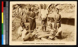 People holding percussion sticks, Cameroon, ca.1920-1940
