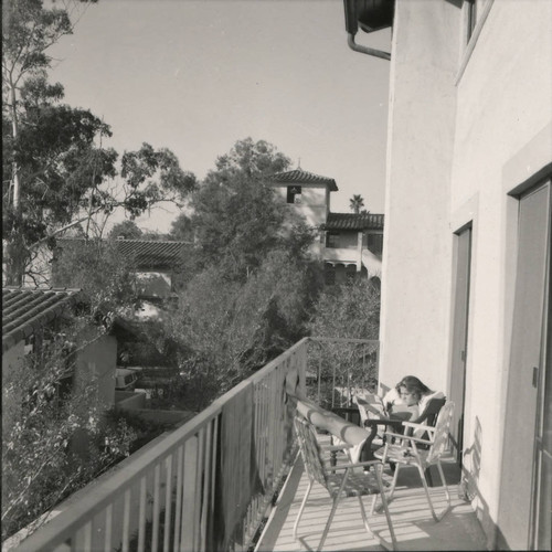 Student reading on balcony, Scripps College