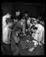 Ray Martin and Arthur Spiller, state champion chess masters playing game, as group of boys watch in Los Angeles, Calif., circa 1953
