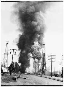 Oil fire at an unidentified oil field, showing a street