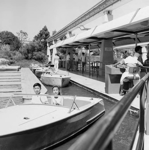 Henry and Susan Quan seated in a boat at Disneyland