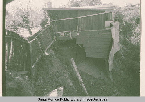 Damaged house after landslide in Las Pulgas Canyon, Calif