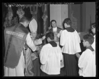 Cardinal James F. McIntyre imposes ashes on foreheads of altar boys in Los Angeles, Calif., 1959