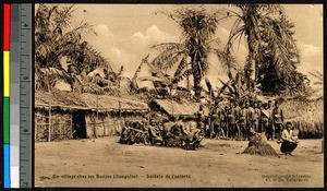 Local soldiers stand in a village, Congo, ca.1920-1940