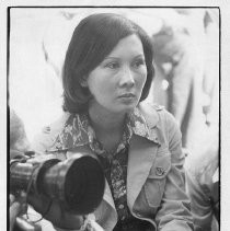 Mai Ky, wife of South Vietnamese VP Nguyen Cao Ky, sits next to a photographer, looking pensive