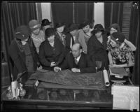 La Crescenta Woman's Club with Supervisor Jessup, going over maps of their community, Los Angeles, 1934