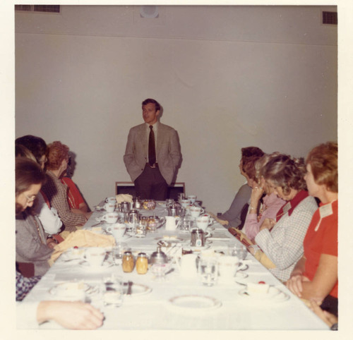 A man speaking at the luncheon