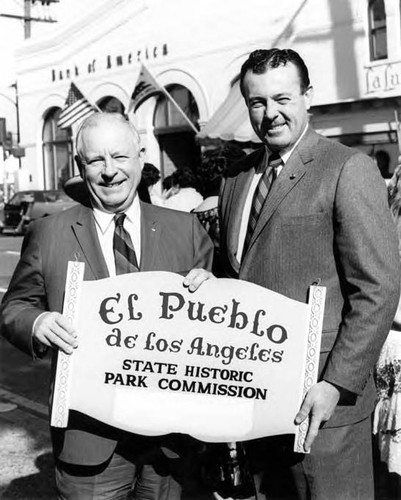 Hubert Laugharn with Dobs holding "El Pueblo De Los Angeles State Historic Park Commission" sign at the Sunset Boulevard closing