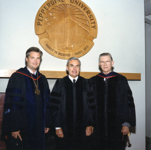 President Davenport, Robert Hood, and Chancellor Runnels beneath the Pepperdine University seal