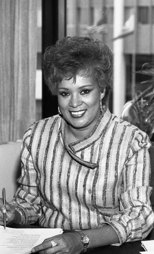 Lillian Daishell sitting at a desk, Los Angeles, 1984