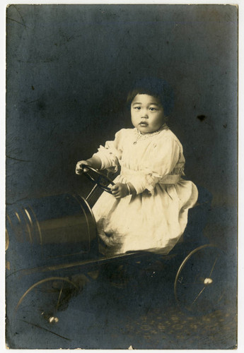 Portrait of Kiyoko Maeda Yoshioka in a toy car