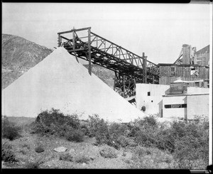 Large stack of salt being piled at a salt mine, California, ca.1910