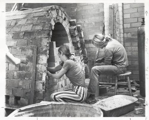 Two students with kiln, Scripps College