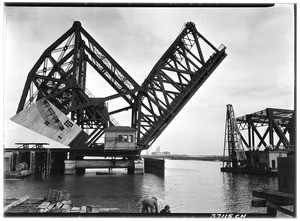 Bascule Bridge opening over the Los Angeles Harbor with a boat passing underneath, 1924