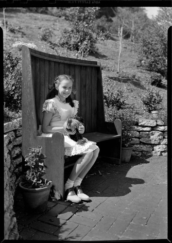 Rennick, Avery, residence. Girl with chicken in garden