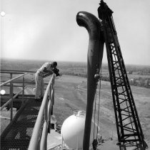 Alpha test stands. Hoisting diffuser ejector into position on Test Stand 1
