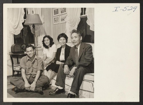 Here are Professor Obata and his family in the living room of their home in Webster Groves. At the left