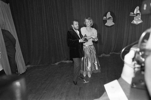 Joe Cocker and Jennifer Warnes posing with a Grammy at the 25th Annual Grammy Awards, Los Angeles, 1983