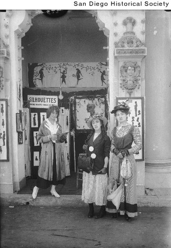 Three women standing outside a silhouette shop