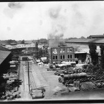 Elevated view of the Southern Pacific Railroad Company yards. This view shows an old office building being demolished