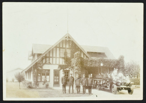 Uniformed firefighters stand in front of Station No. 4, 4th and Loma