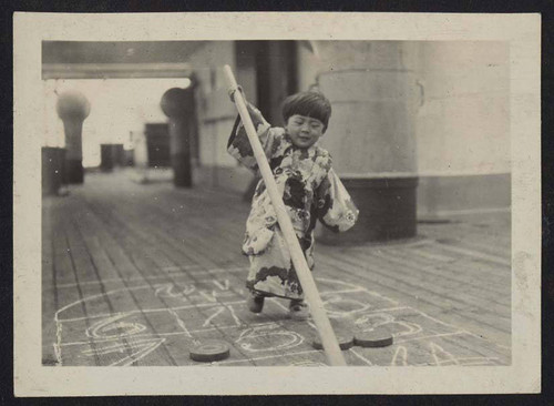 Young child playing shuffleboard