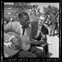Blues guitarist Son House playing as professor Dr. D. K. Wilgus records music at 3rd annual UCLA Folk Festival, 1965