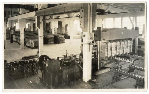 Interior of mill showing stacks of veneer wood, California