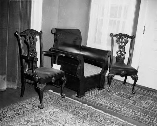 2 chippendale-ish chairs by a big wooden chair