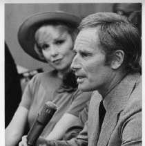 Actor Charlton Heston testifies before the legislature to support funds for the arts (Edie Adams to his left)