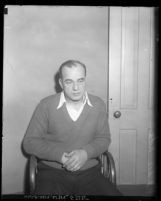 Los Angeles police detective Edward "Eddie" P. Nolan sitting in chair, charged with murder, circa 1931
