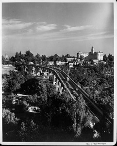 An aerial view of the Colorado Street Bridge with the Vista Del Arroyo Hotel to the right and the Pasadena City Hall to the left