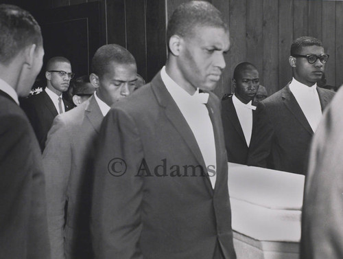 Malcolm X and pallbearers carrying the casket of Ronald Stokes, Los Angeles, May 5, 1962