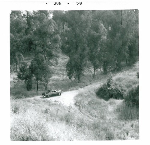 Car on Dirt Road, Taken from Hill Above