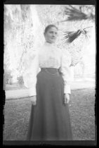 Portrait of woman outdoors, in white blouse and dark skirt