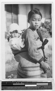 Korean girl carrying a baby on her back, Korea, ca. 1920-1940