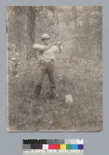 Man [Roland L. Oliver?] shooting a gun, Idaho trip. [photographic print]