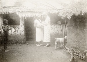 Bathing a baby's eyes, Nigeria, ca. 1935