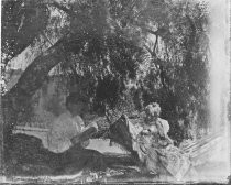 Two women seated under a tree with hammock, c. 1912