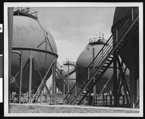 Close-up exterior view of Butadiene storage tanks of the Shell Chemical Company, ca.1940