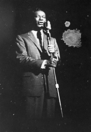 Nat 'King' Cole performing on stage